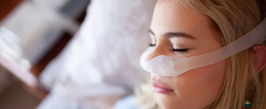 Girl with sleep apnea wearing CPAP while sleeping