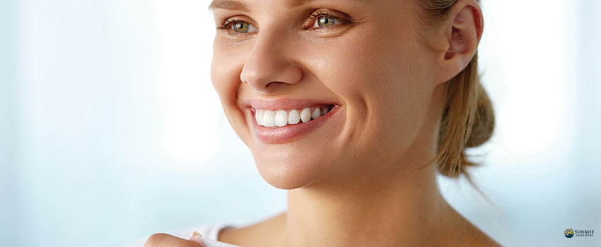 Woman Using Teeth Whitening Strip