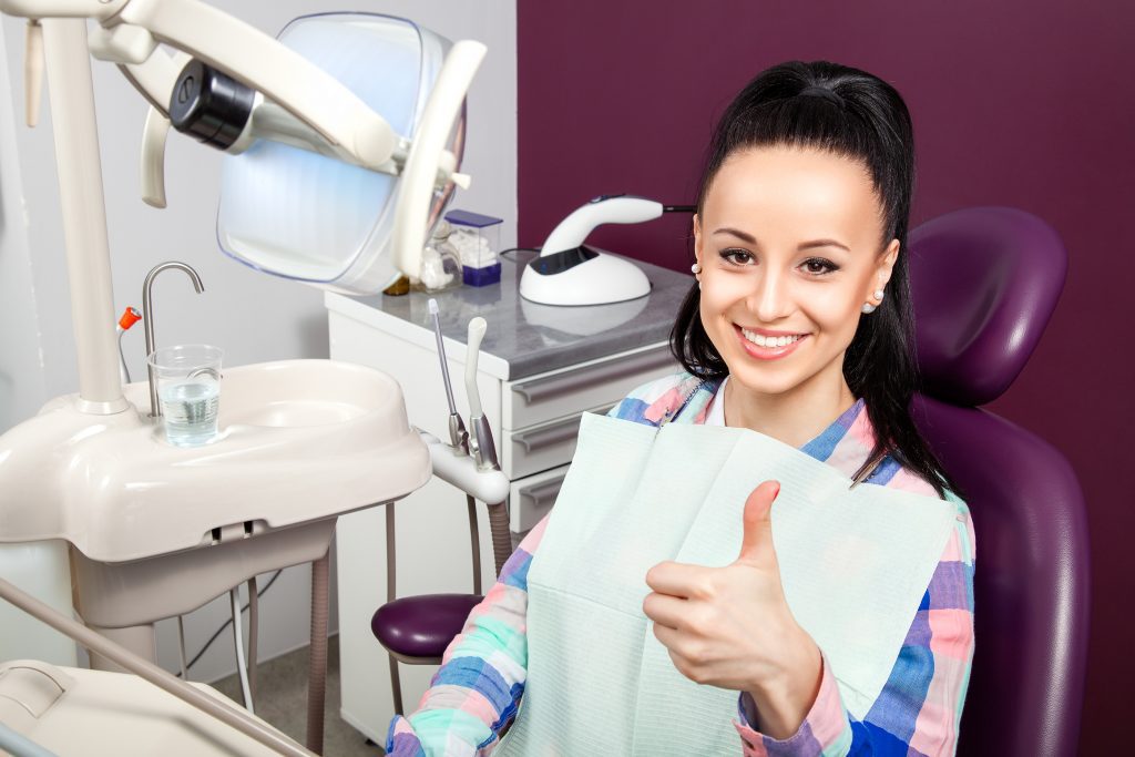SD Woman With White Teeth With Thumb Up Waiting For Dentist