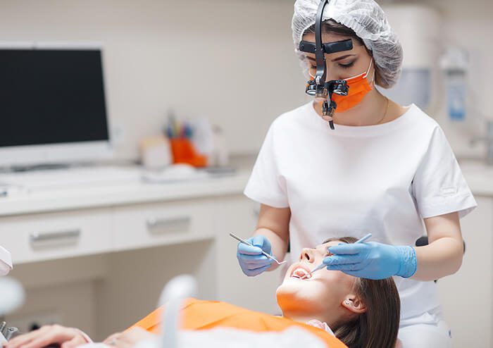 SD Dentist inspecting patient's teeth