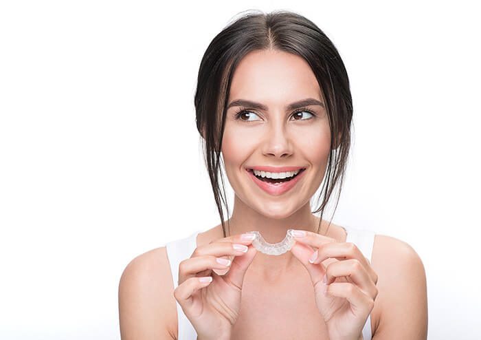 SD Woman holding invisalign braces