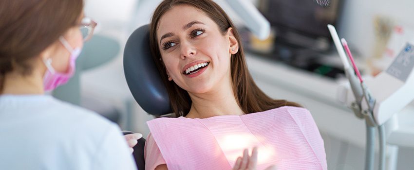 SD Woman Smiling at her Dentist
