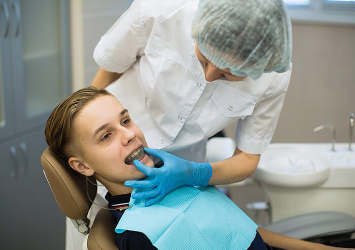 SD Teenager getting his teeth measured for braces
