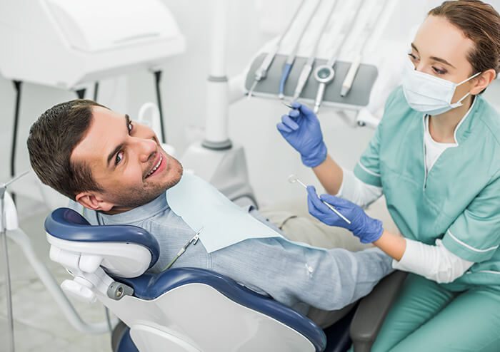 SD Patient Smiling as Dentist Prepares to check his teeth